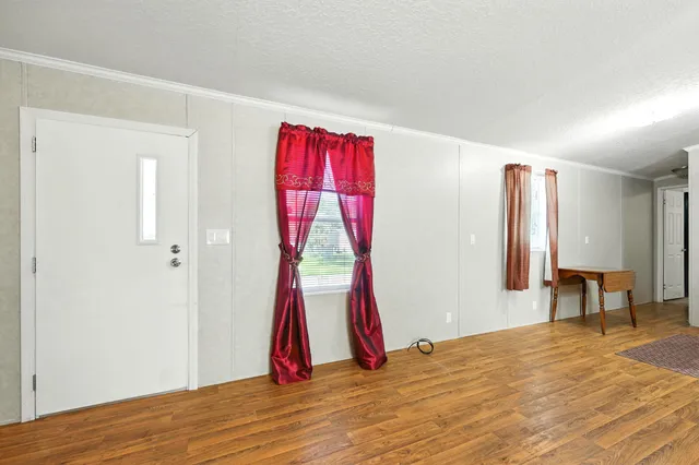 a living room with furniture and kitchen view