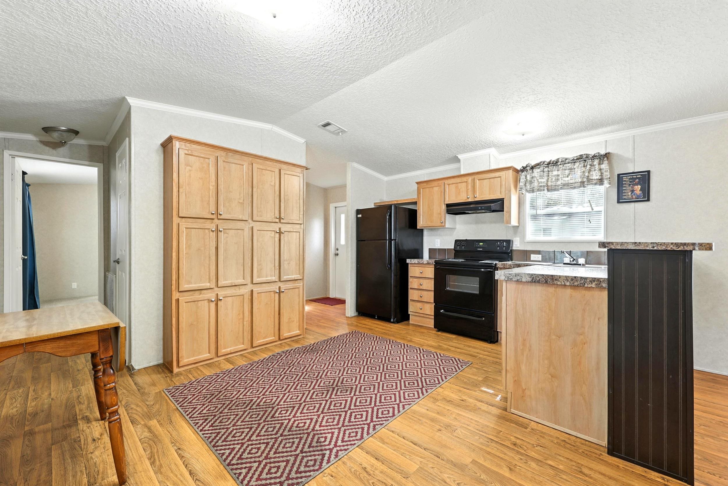 300 East Carter Street Hastings, FL 32145 - Photo 10 of 41 a kitchen with granite countertop stainless steel appliances a refrigerator and a stove top oven