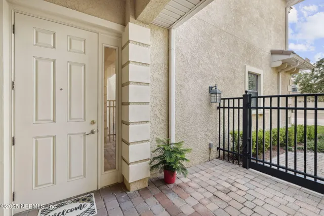 a dining room with furniture and large windows
