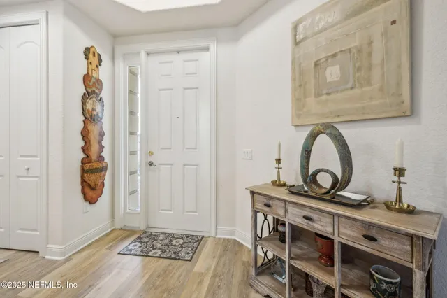 a living room with furniture a flat screen tv and a window