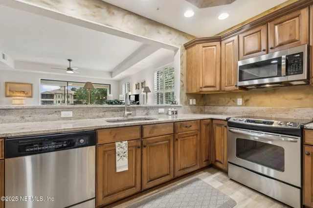 a view of walk in closet with clothes