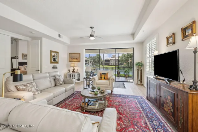 a living room with furniture and a floor to ceiling window