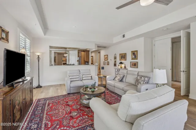 a view of a big yard with plants and large trees