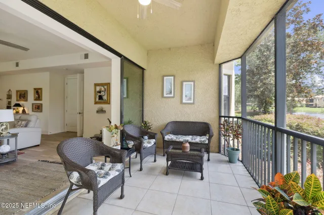 a view of house with a yard and potted plants