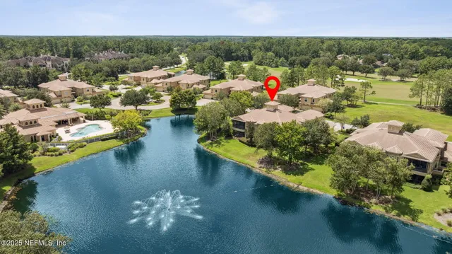 a view of a lake with houses in the background