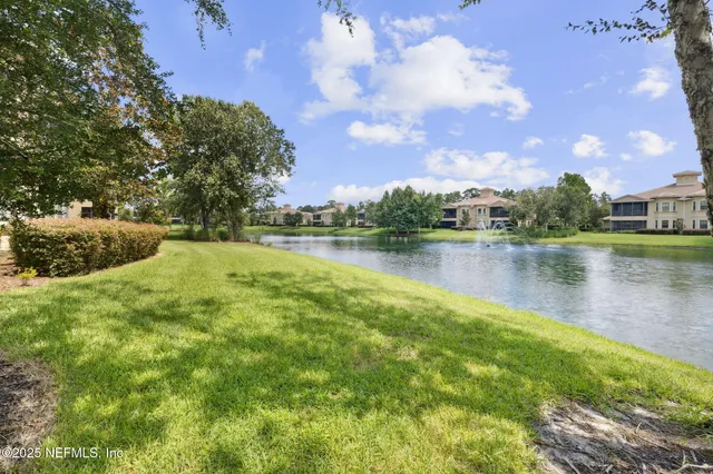 a living room with furniture a flat screen tv and a large window
