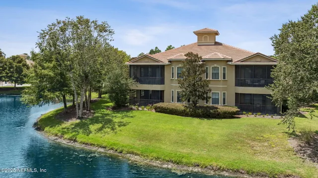 an aerial view of a house with a garden and swimming pool