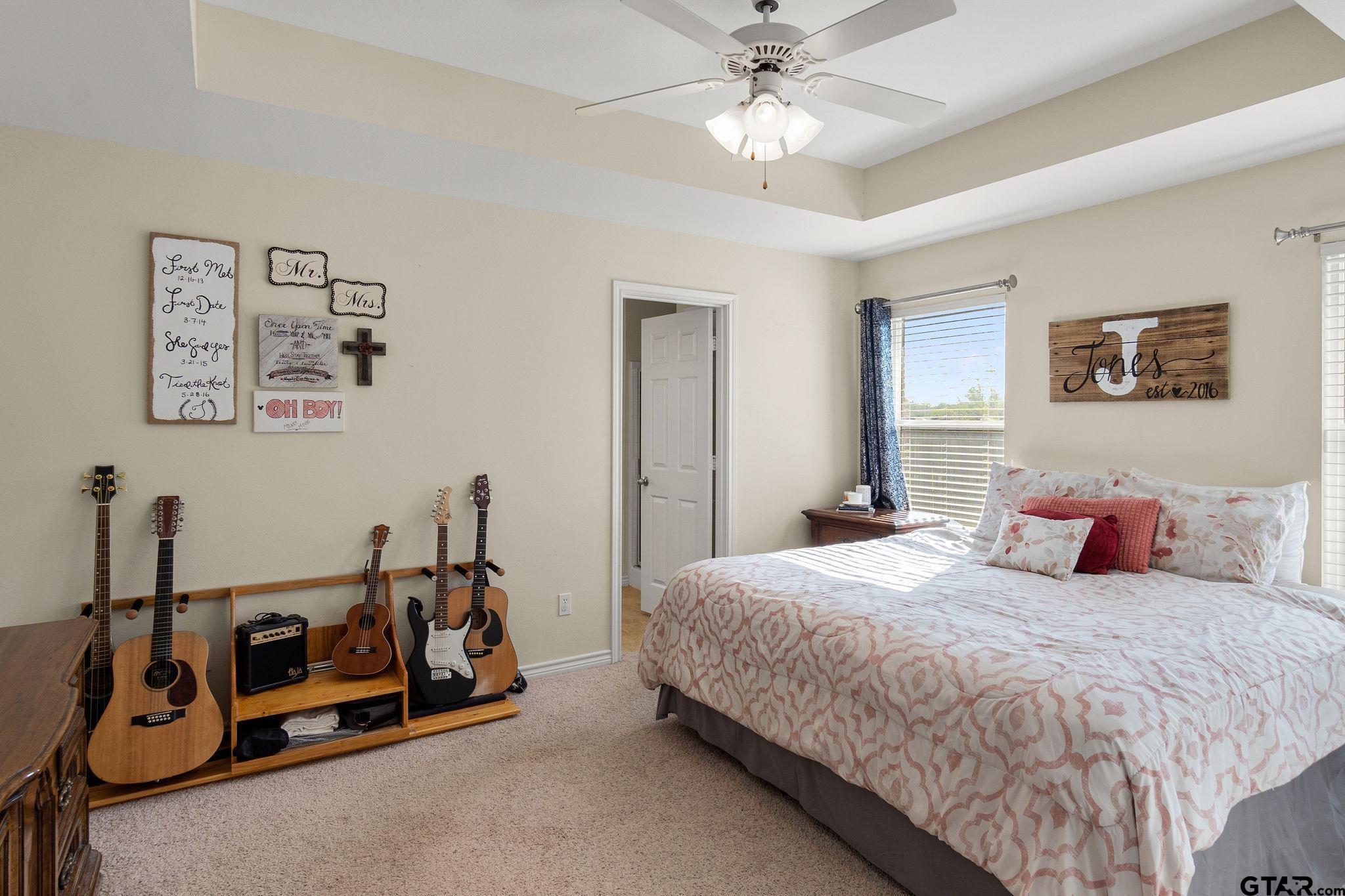 11269 Twin Spires Drive Flint, TX 75762 - Photo 13 of 23 a bedroom with a bed and a chandelier