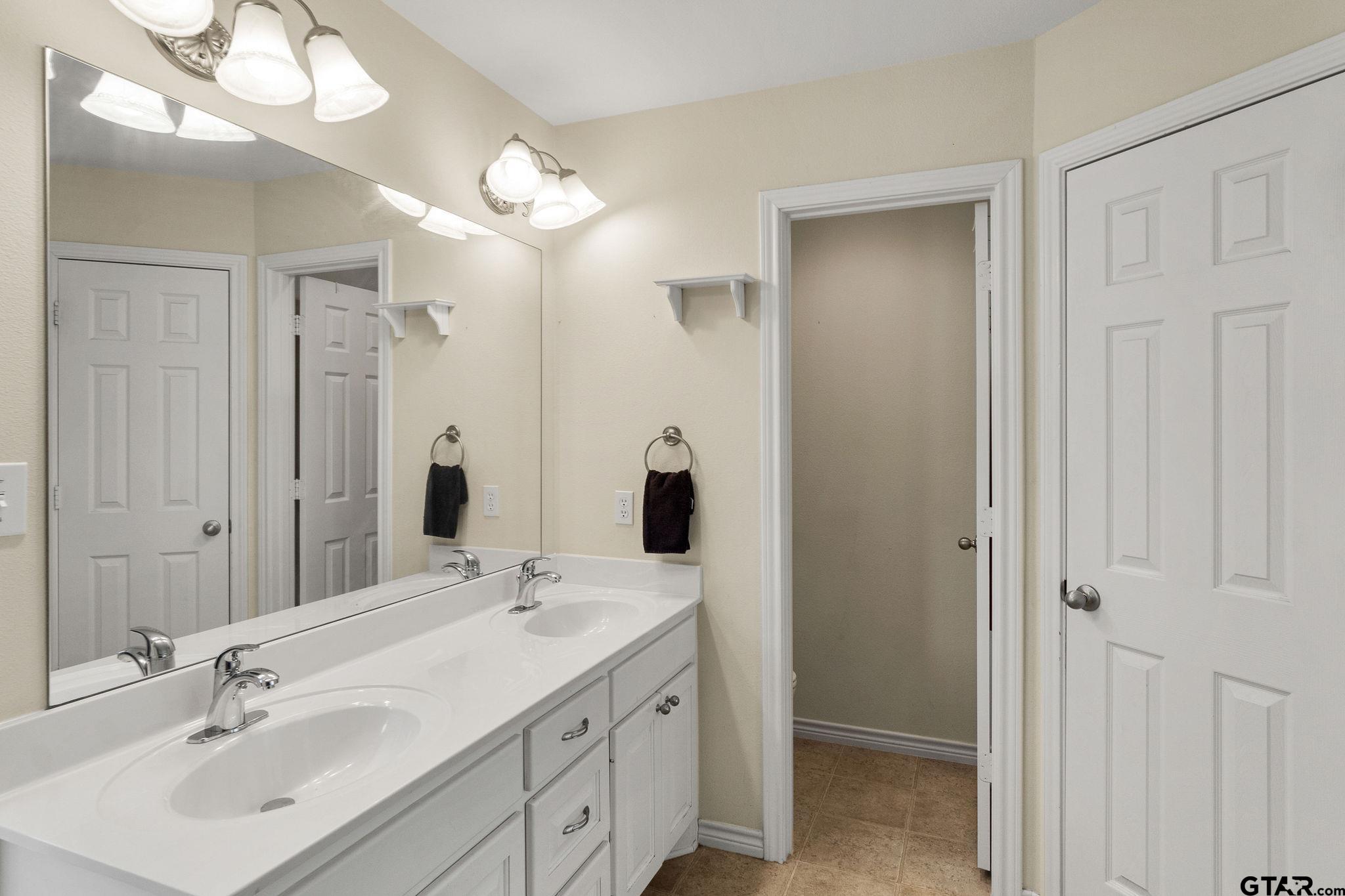 11269 Twin Spires Drive Flint, TX 75762 - Photo 14 of 23 a bathroom with a double vanity sink and a mirror