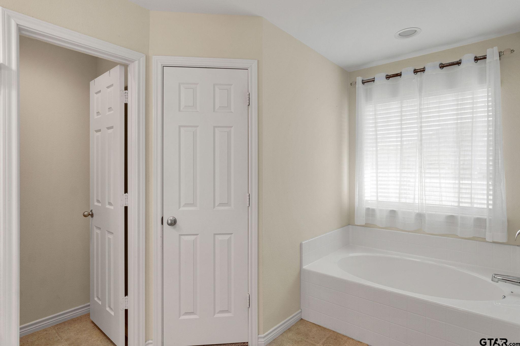 11269 Twin Spires Drive Flint, TX 75762 - Photo 15 of 23 a white bath tub sitting in a bathroom next to a window