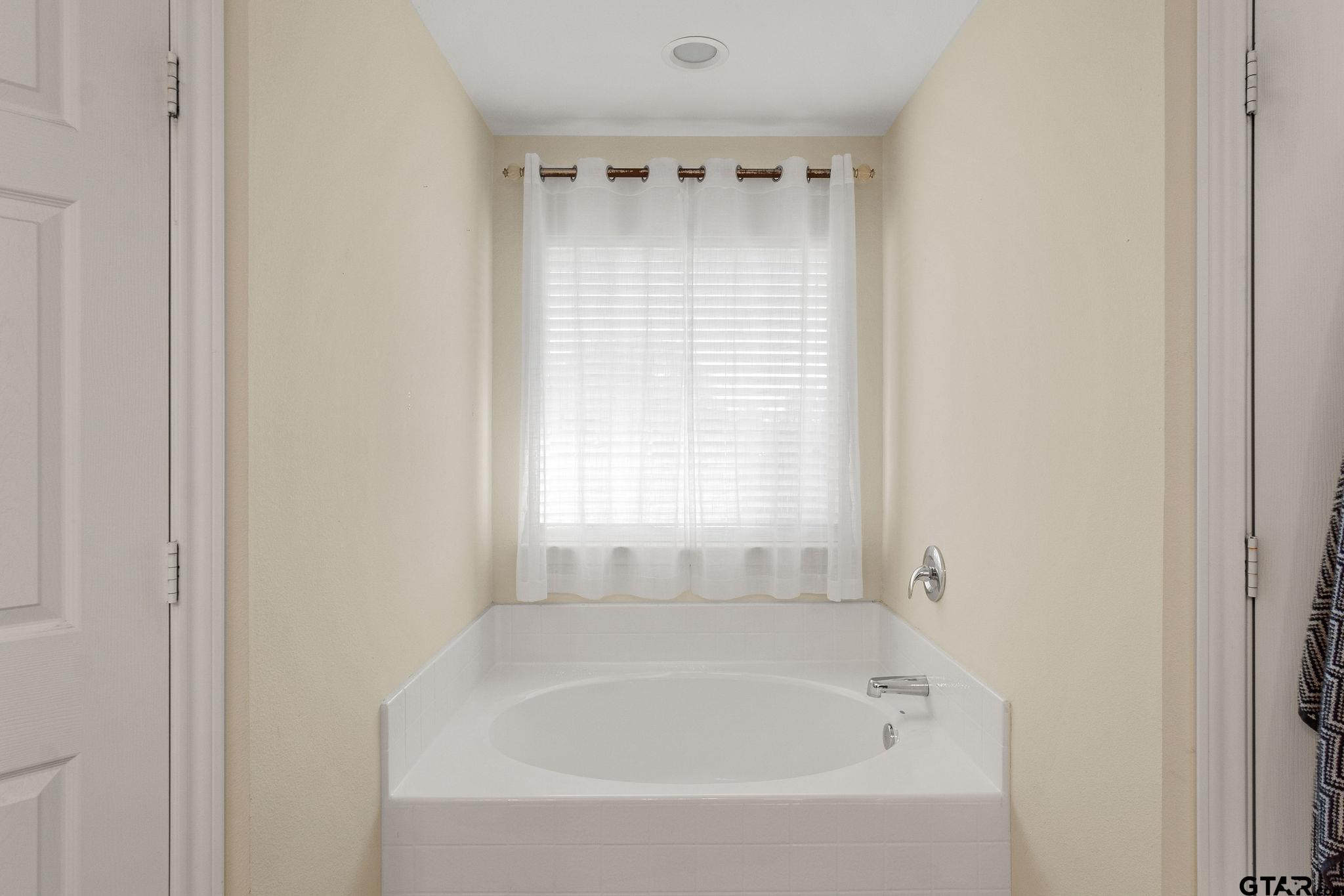 11269 Twin Spires Drive Flint, TX 75762 - Photo 16 of 23 a white bath tub sitting next to a window