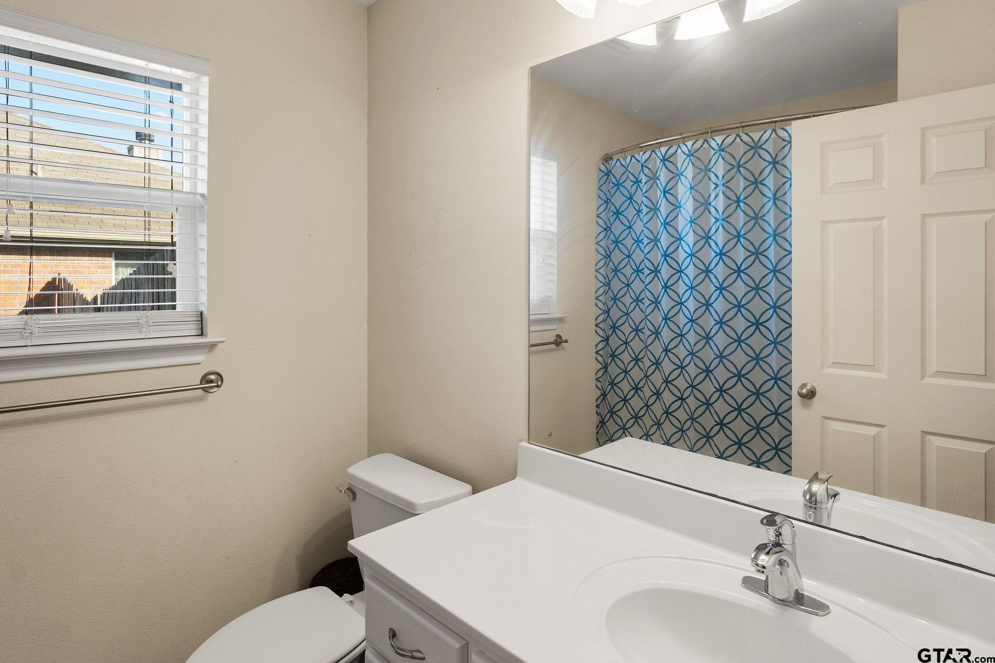 11269 Twin Spires Drive Flint, TX 75762 - Photo 19 of 23 a bathroom with a sink and a toilet