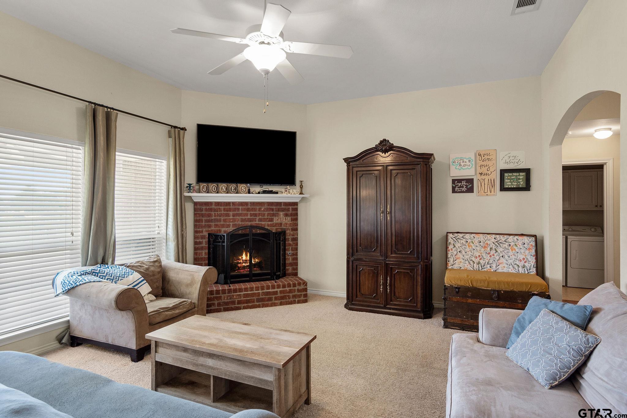 11269 Twin Spires Drive Flint, TX 75762 - Photo 5 of 23 a living room with furniture a flat screen tv and a fireplace
