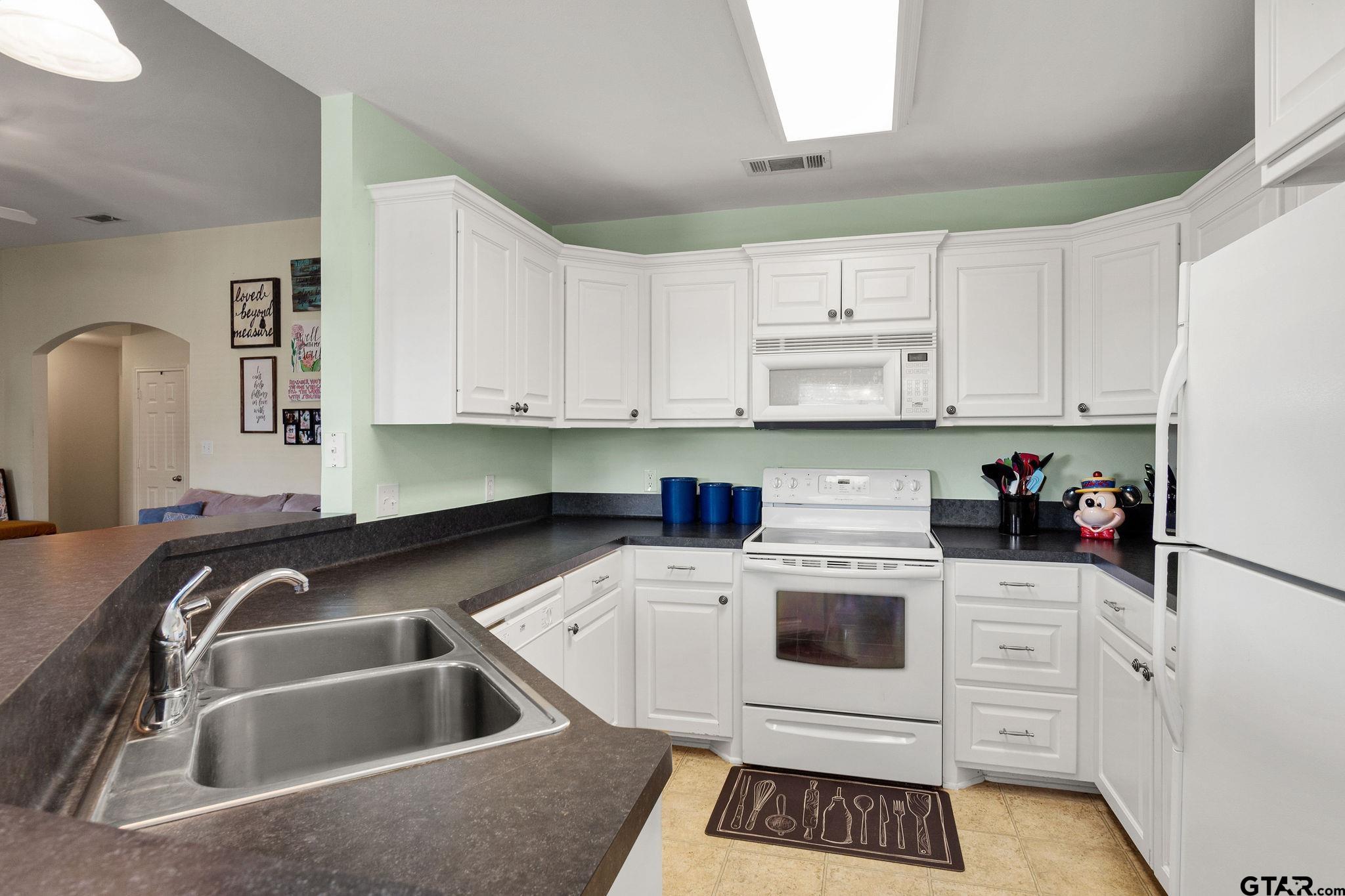 11269 Twin Spires Drive Flint, TX 75762 - Photo 9 of 23 a kitchen with white cabinets and white appliances