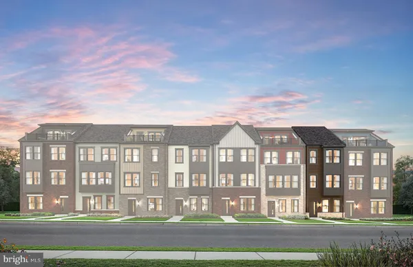a front view of a residential apartment building with a yard