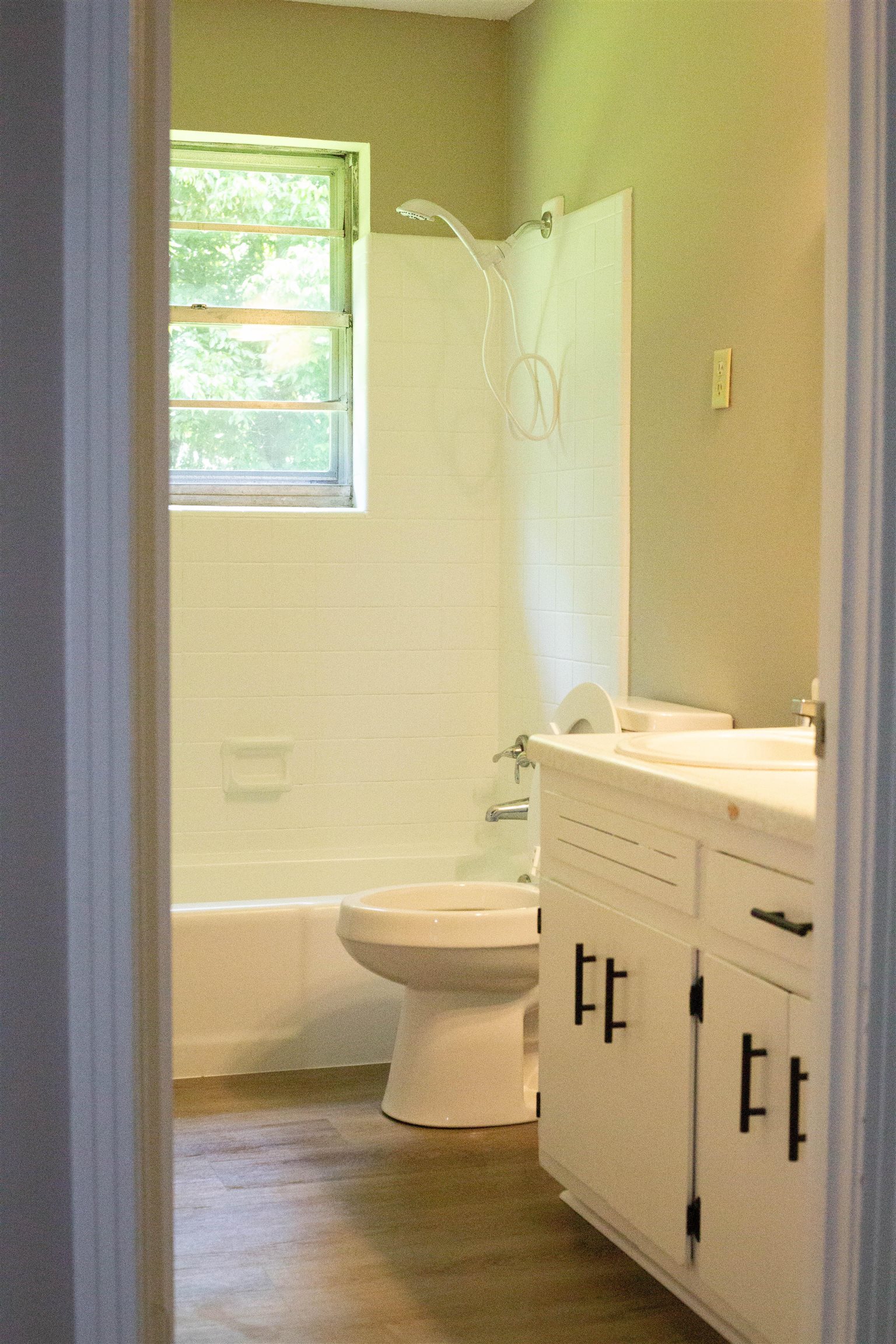 583 Armstrong Road Drummonds, TN 38023 - Photo 9 of 14 Bathroom featuring a white bathtub, toilet, and vanity with dual sinks