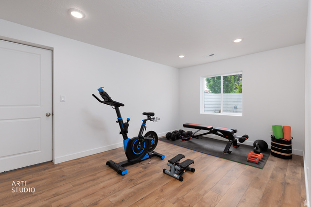 1654 South 730 West Provo, UT 84601 - Photo 24 of 33 Bright room featuring wood-finish flooring, white walls, recessed lighting, and a single window with horizontal blinds