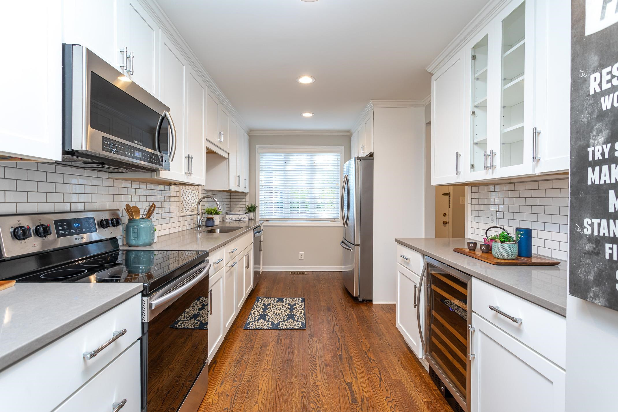 2943 Wycliff Road Raleigh, NC 27607 - Photo 11 of 31 a kitchen with stainless steel appliances kitchen island granite countertop a stove a sink and a microwave