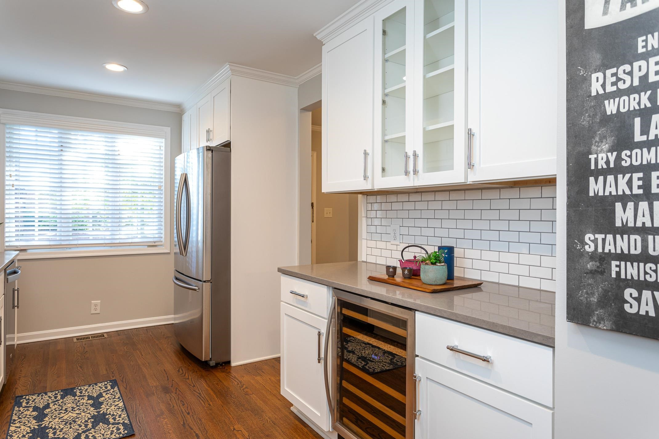 2943 Wycliff Road Raleigh, NC 27607 - Photo 12 of 31 a kitchen with stainless steel appliances a sink a refrigerator and wooden floor