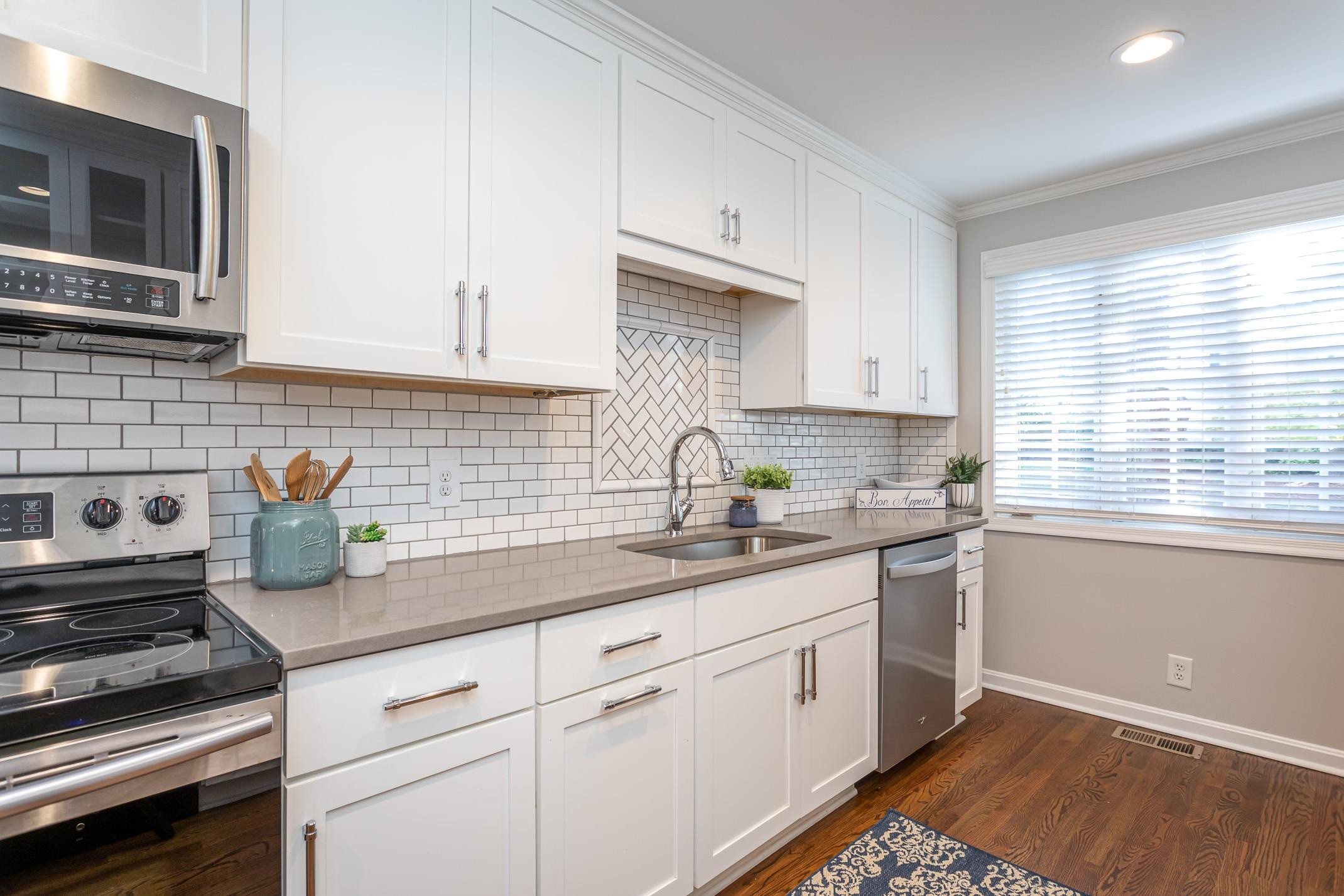 2943 Wycliff Road Raleigh, NC 27607 - Photo 13 of 31 a kitchen with a sink stove and microwave