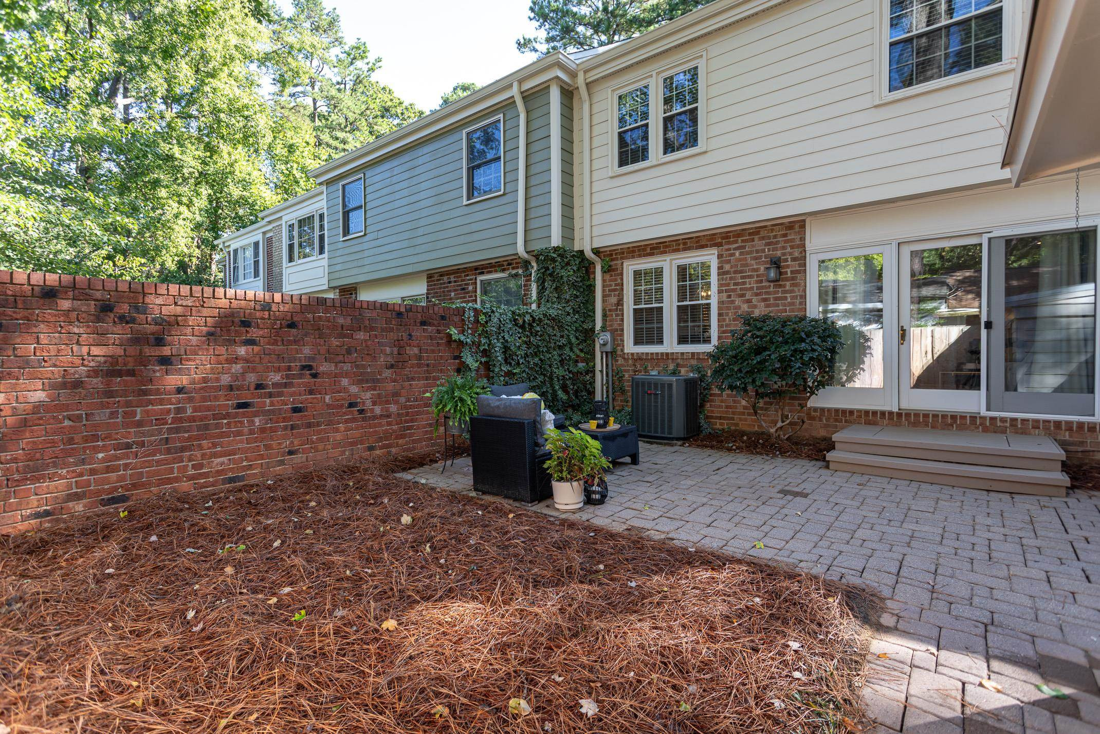 2943 Wycliff Road Raleigh, NC 27607 - Photo 21 of 31 a view of a house with backyard sitting area and garden