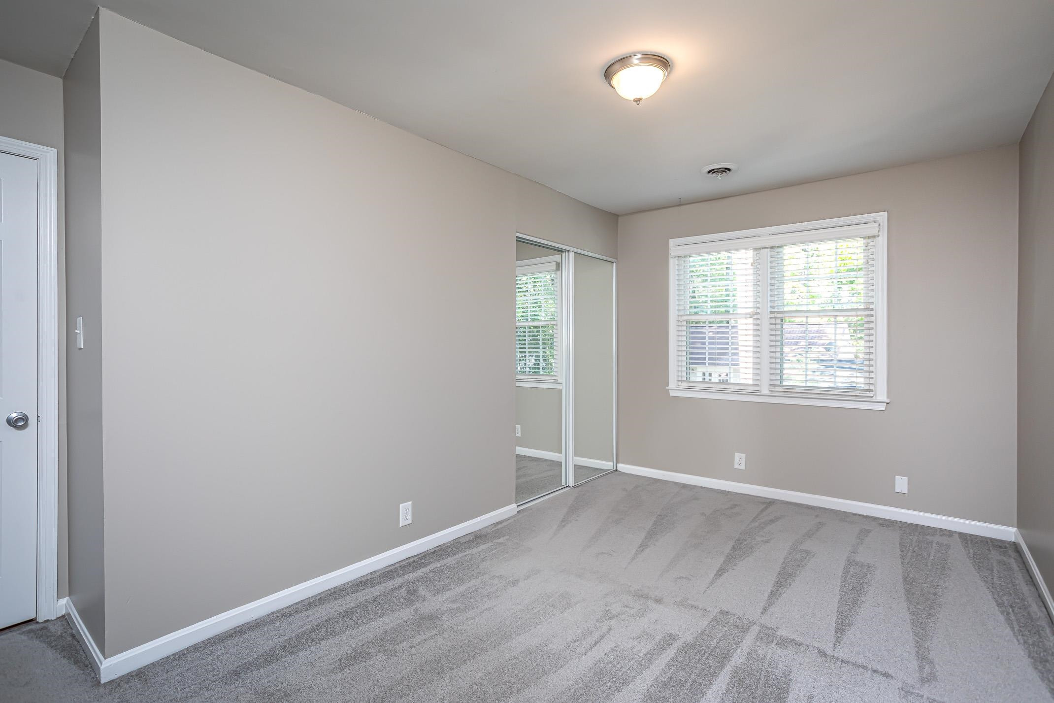 2943 Wycliff Road Raleigh, NC 27607 - Photo 29 of 31 an empty room with wooden floor and windows