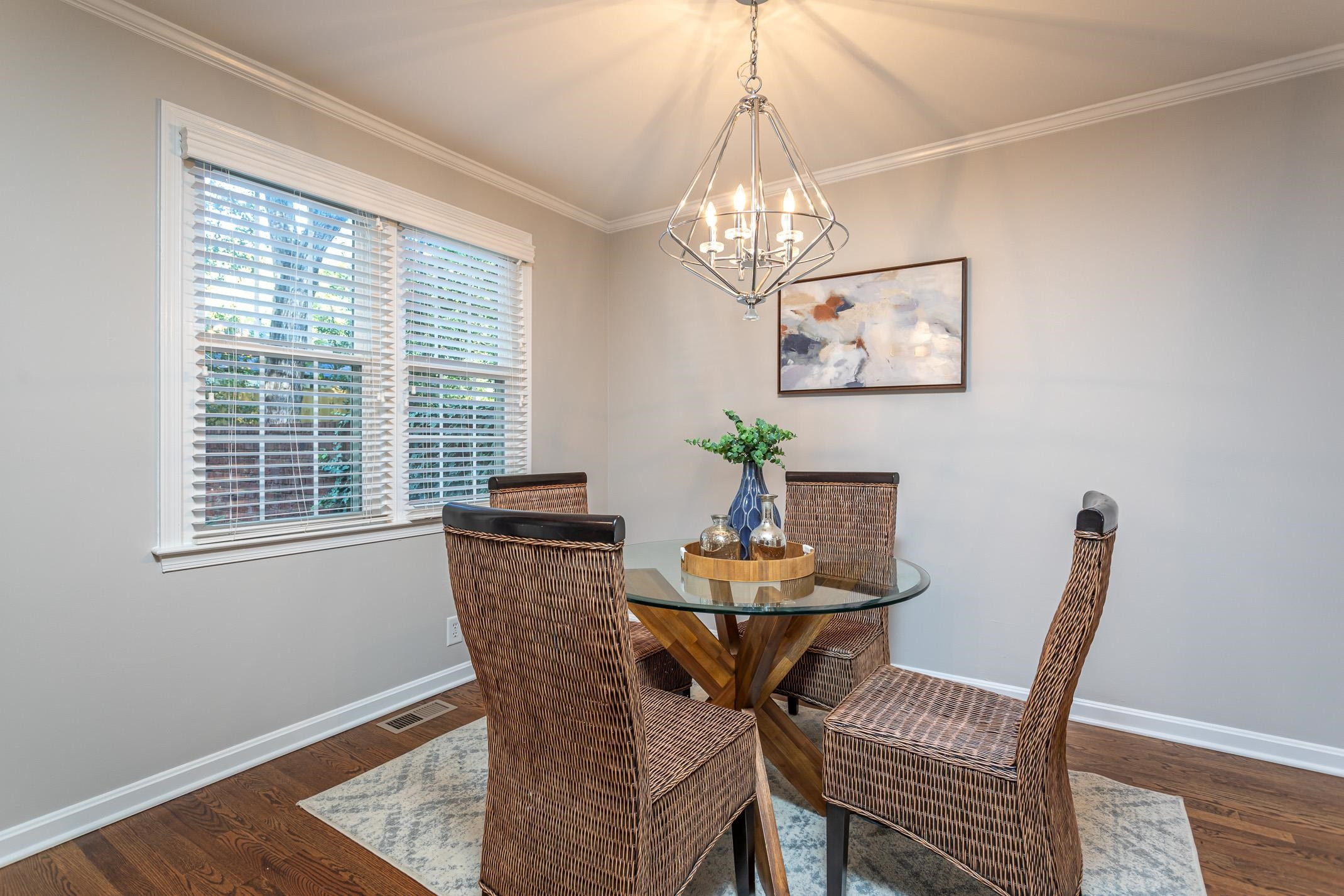 2943 Wycliff Road Raleigh, NC 27607 - Photo 7 of 31 a view of a dining room with furniture a chandelier and wooden floor