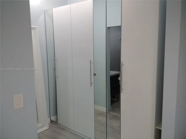 a bedroom with a bed and wall painting