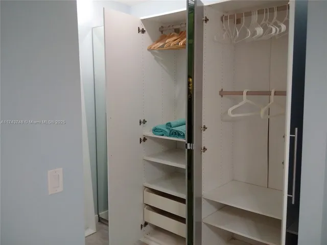 a utility room with a sink and a mirror