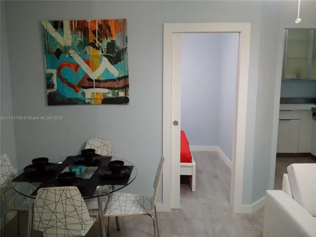 a living room with furniture and a painting on the wall