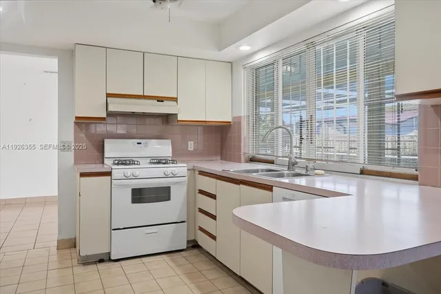 a kitchen with a stove a sink and a refrigerator