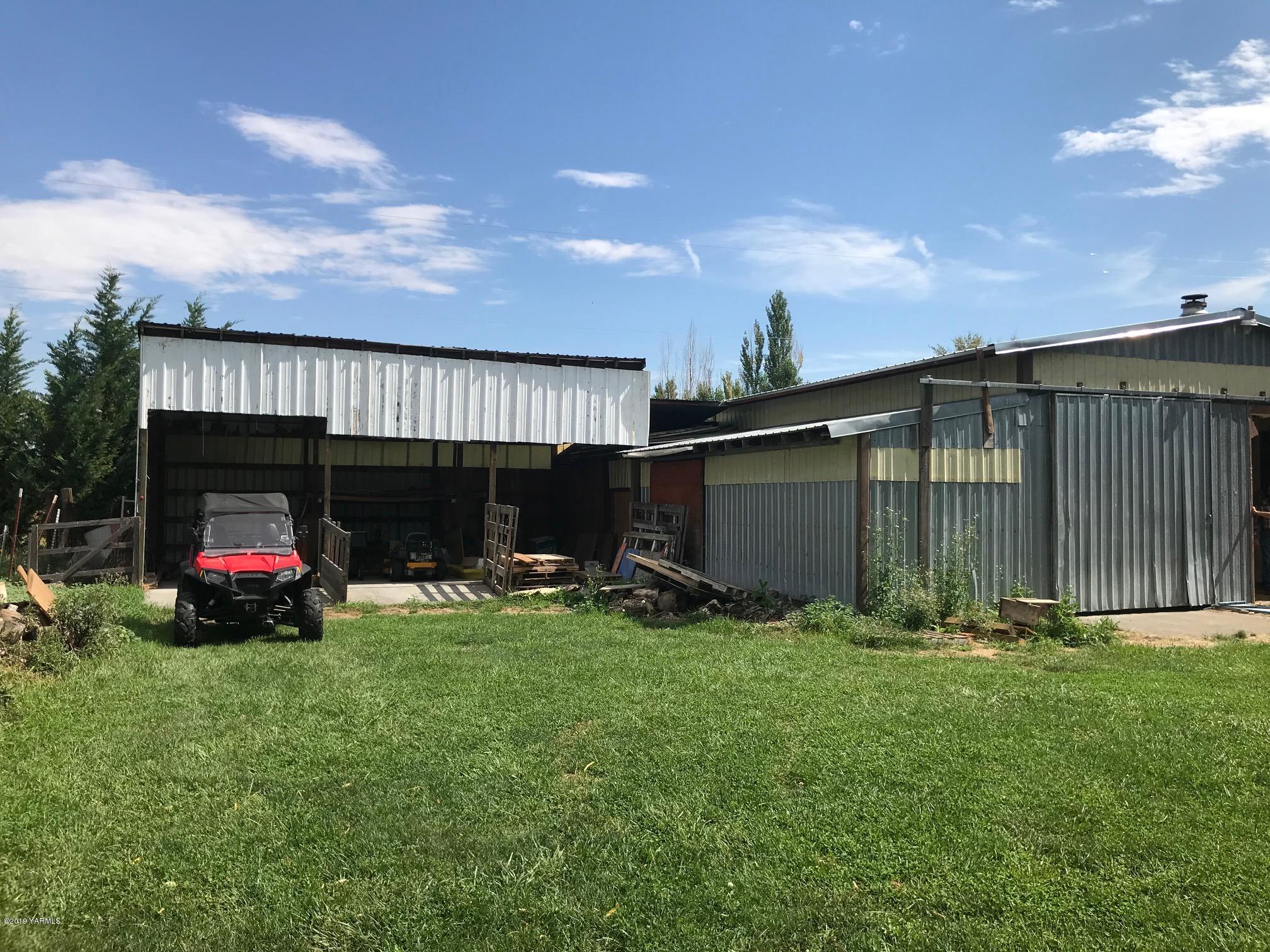 4031 Bell Road Yakima, WA 98901 - Photo 6 of 28 a view of a backyard with sitting area and garage
