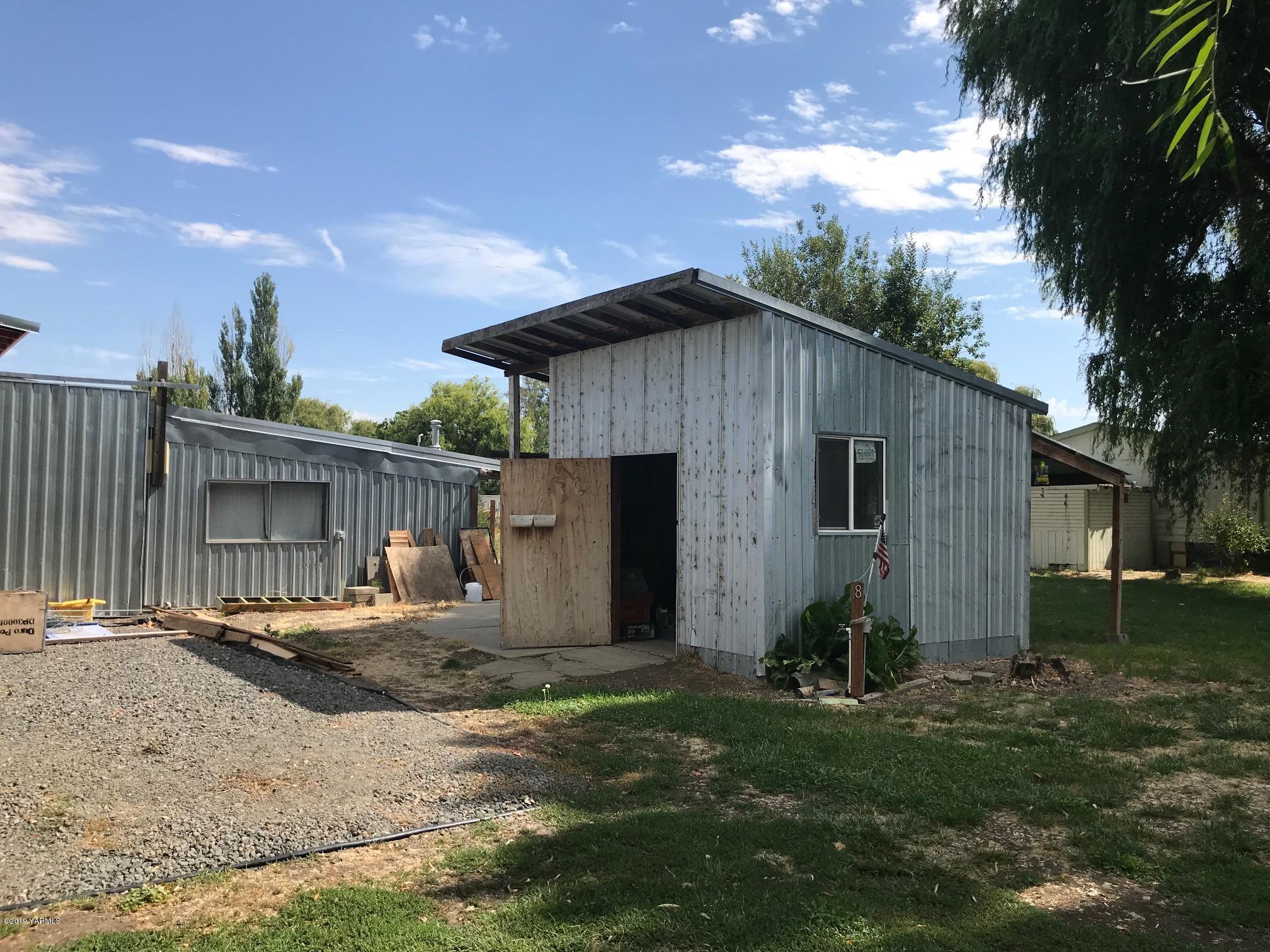 4031 Bell Road Yakima, WA 98901 - Photo 7 of 28 a backyard of a house with barbeque oven table and chairs