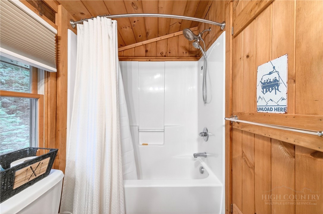 376 Yellow Bear Road Todd, NC 28684 - Photo 23 of 29 a bathroom with a shower curtain and a window