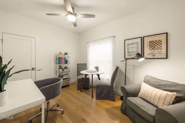 a living room with furniture a desk and chair