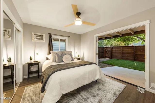 a bed sitting in a spacious bedroom next to a window