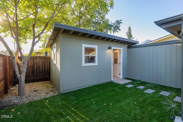 a view of an house with backyard space and garden