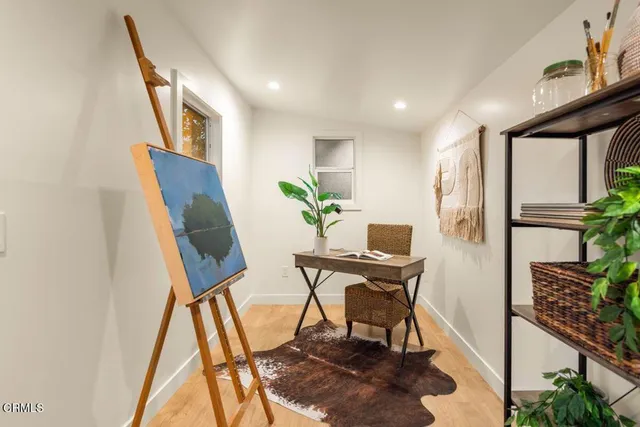 a view of a workspace with furniture and a potted plant