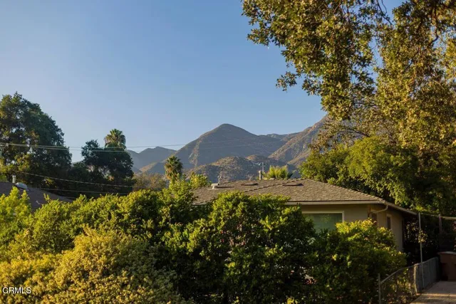 a view of a house with a yard and sitting area