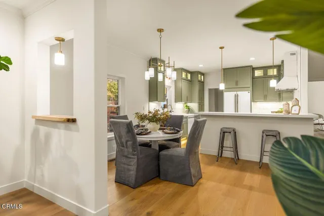 a view of a dining room with furniture and a chandelier