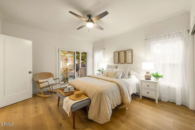 a bedroom with a bed a couch and a window