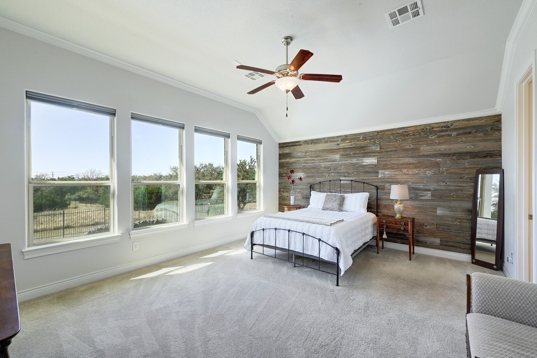 960 Blue Ridge Drive Dripping Springs, TX 78620 - Photo 11 of 38 Bedroom featuring wood walls, vaulted ceiling, carpet, a ceiling fan, and ornamental molding