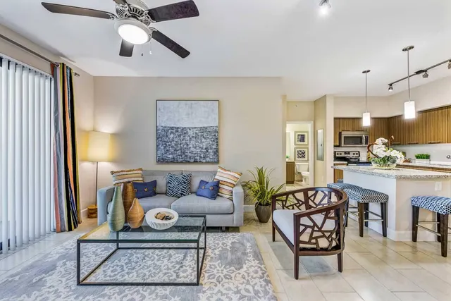 a living room with furniture and kitchen view