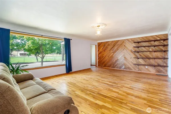 a view of a room with wooden floor and cabinet