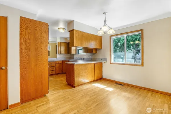 a kitchen with stainless steel appliances granite countertop a granite counter tops and a refrigerator