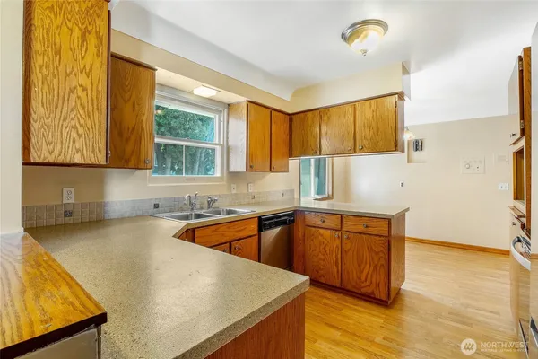 a kitchen with stainless steel appliances granite countertop a refrigerator and a stove top oven