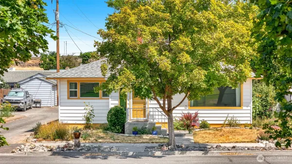 a view of a house with a tree in front