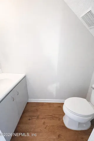 a bathroom with a toilet and a vanity