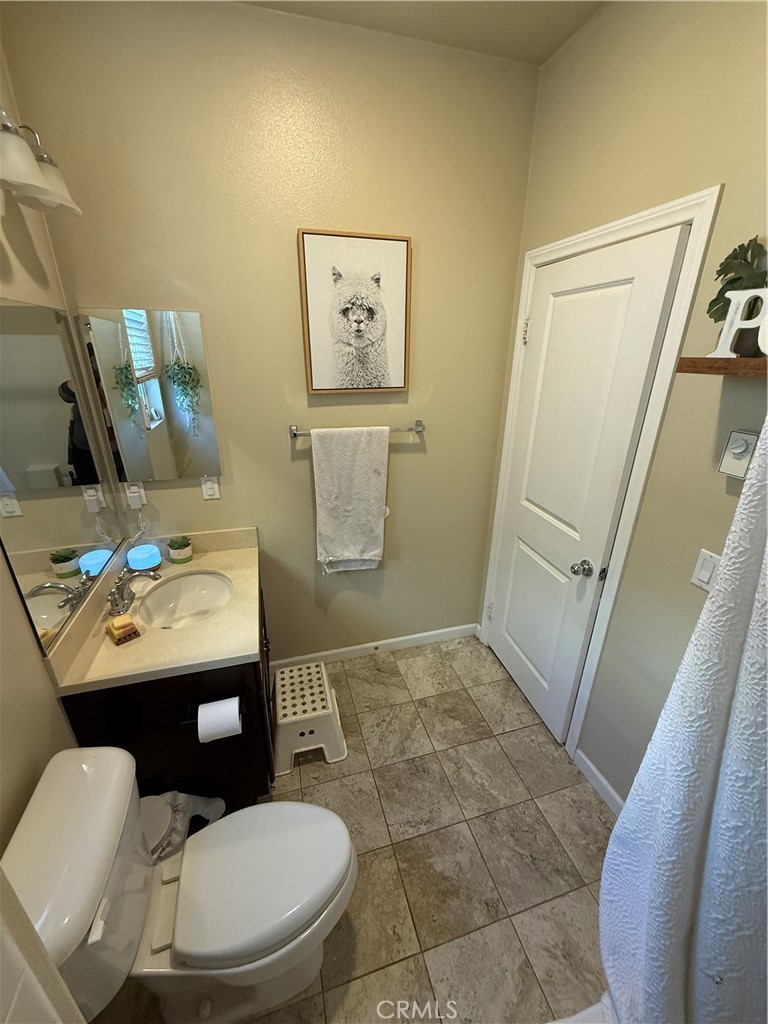 30130 Pine Needle Road Menifee, CA 92585 - Photo 13 of 45 a bathroom with a toilet sink and mirror