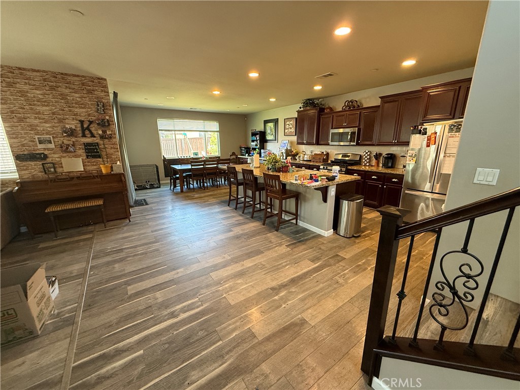 30130 Pine Needle Road Menifee, CA 92585 - Photo 16 of 45 a living room with lots of furniture and kitchen view